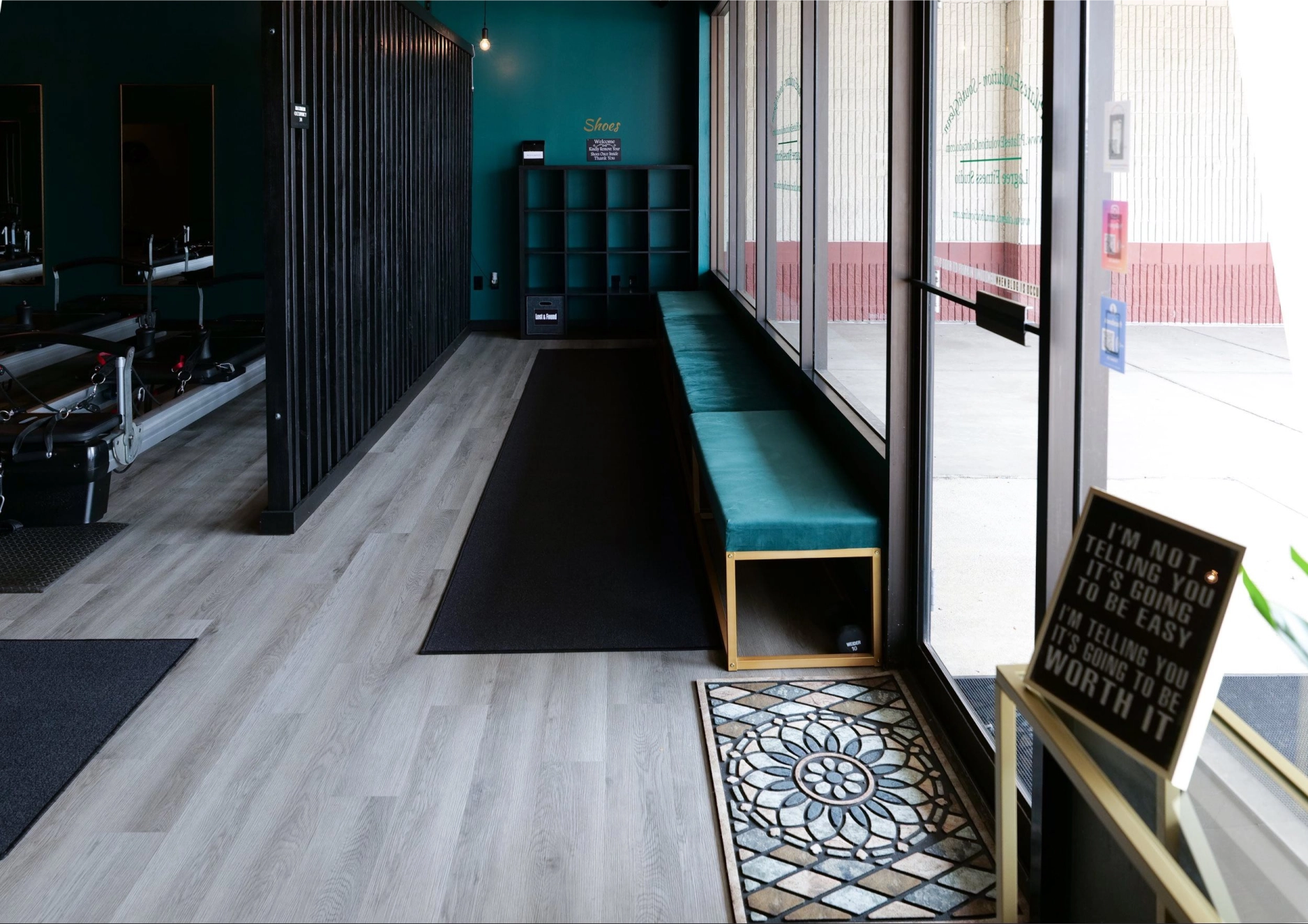 The studio entrance with a teal velvet bench, at The Streets at SouthGlenn
